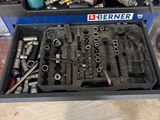 a box of tools sitting on the floor next to a bottle of water