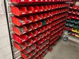 many red bins on the shelves in the warehouse