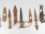 many different types of knives on a white surface