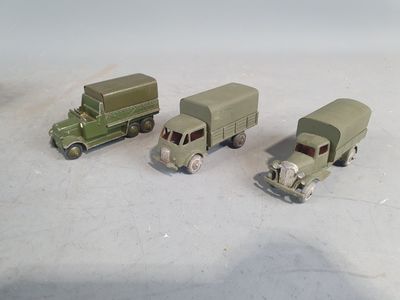 three toy trucks sitting next to each other on a table