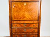 a small wooden cabinet with drawers and a marble top