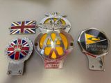 several different badges are sitting on top of a table