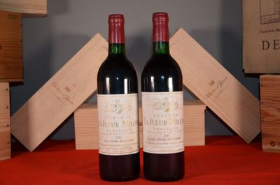 two bottles of wine sitting next to each other on a table