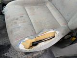 a seat in the back of a car with a bottle in it