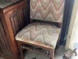a chair that is sitting in front of a cabinet