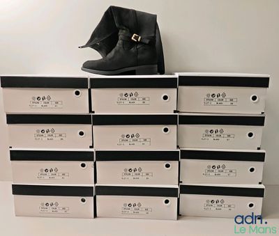 une pile de cartons sur laquelle est posée une paire de chaussures