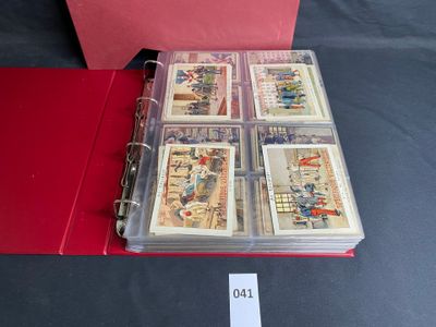 a red binder with a lot of cards inside of it