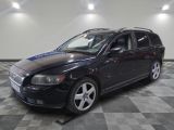 a picture of a black volvo wagon parked in a garage
