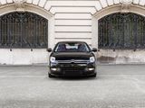 a black car that is parked in front of a building