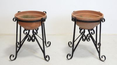 pair of wrought iron plant stands with terracotta pots on stands