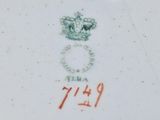 a close up of a plate with a crown and a ring on it