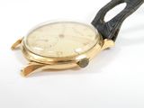 a watch that is sitting on a white surface