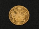 a close up of a gold coin on a black surface