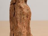 a small statue of a woman sitting on a table