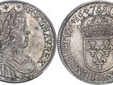 a silver coin with a crown on top of it