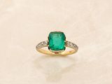 an image of a ring with a green stone