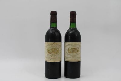 two bottles of wine sitting next to each other on a white surface