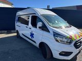 a white van parked in front of a building