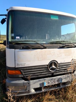 a white truck that is sitting in the grass