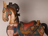a wooden horse that is sitting on a table