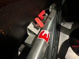 a close up of a motorcycle seat with a red and white sticker on it