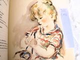 an open book with a picture of a little girl holding a cat