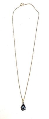 the necklace has a black flower on it on a silver chain