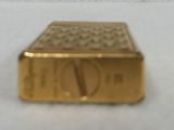a close up of a small gold object on a white surface
