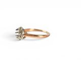 a close up of a gold ring with a diamond on it