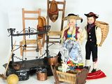 a figurine of a man and a woman standing next to a chair