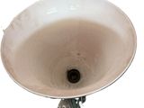 a white sink with a metal faucet in it