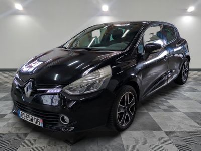 the black car is parked on a checkered floor in the garage