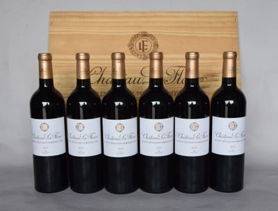 six bouteilles de vin sont alignées devant une caisse en bois