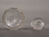 two clear glass vases sitting next to each other on a table