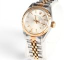 an image of a woman ' s wrist watch on a white surface