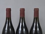 three bottles of wine that are sitting on a table