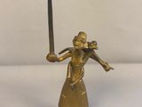 a statue of a woman holding an umbrella on a table