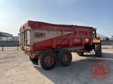 a red dump truck that is parked in a parking lot