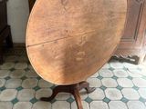 a wooden table with a wooden top on a tiled floor