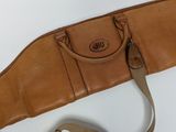 a brown bag and a cell phone on a white table