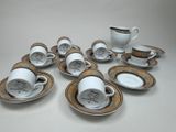several cups and saucers are sitting on a white table