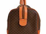 a brown and tan handbag with a brown handle