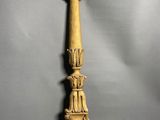a gold candle holder on a grey background with a gray background