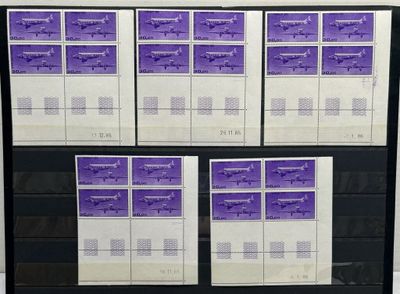 purple and white stamps are on a black shelf in front of a white wall