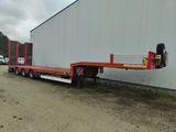 a flatbed trailer parked in front of a building