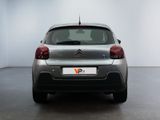 the rear of a silver citrole parked in a white room