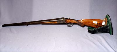 an old rifle with a wooden barrel and a leather case