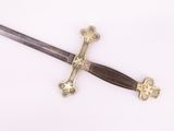 a sword that is laying on a white surface