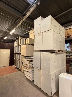 many stacks of boxes stacked on top of each other in a warehouse