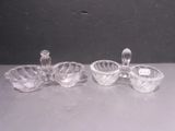 two clear glass bowls and a candle holder on a table